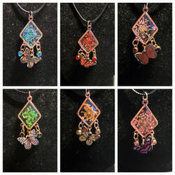 Six dried flower pendants with butterfly charms